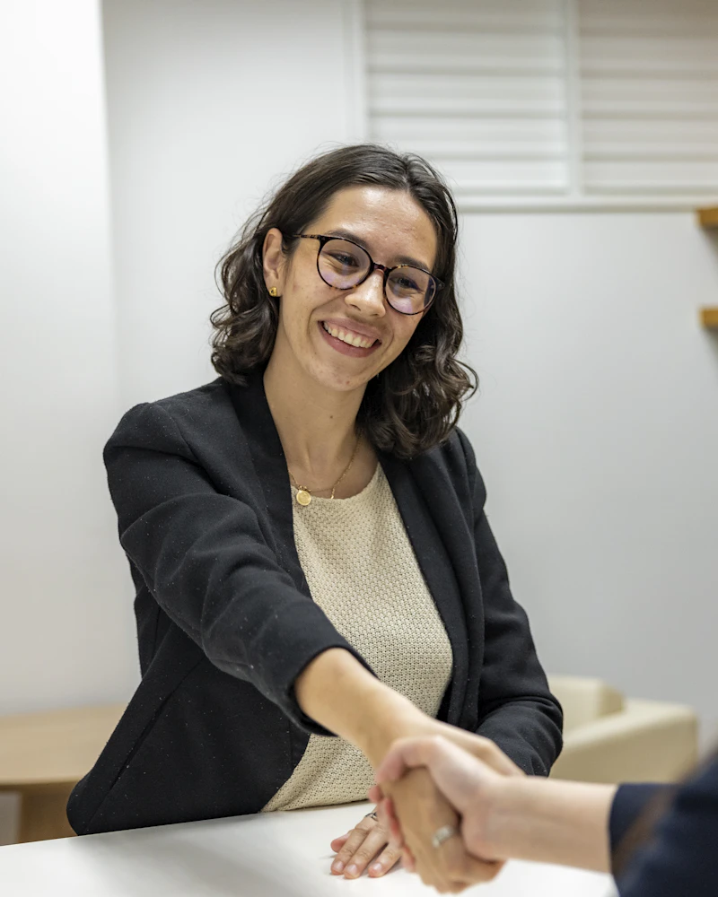 Profissional de RH cumprimenta candidata em entrevista